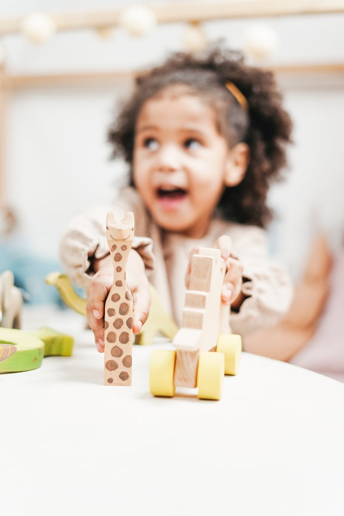 Crafting Captivating Headlines: Your awesome post title goes here A happy child with curly hair enjoys playing with wooden toys in a bright indoor setting.